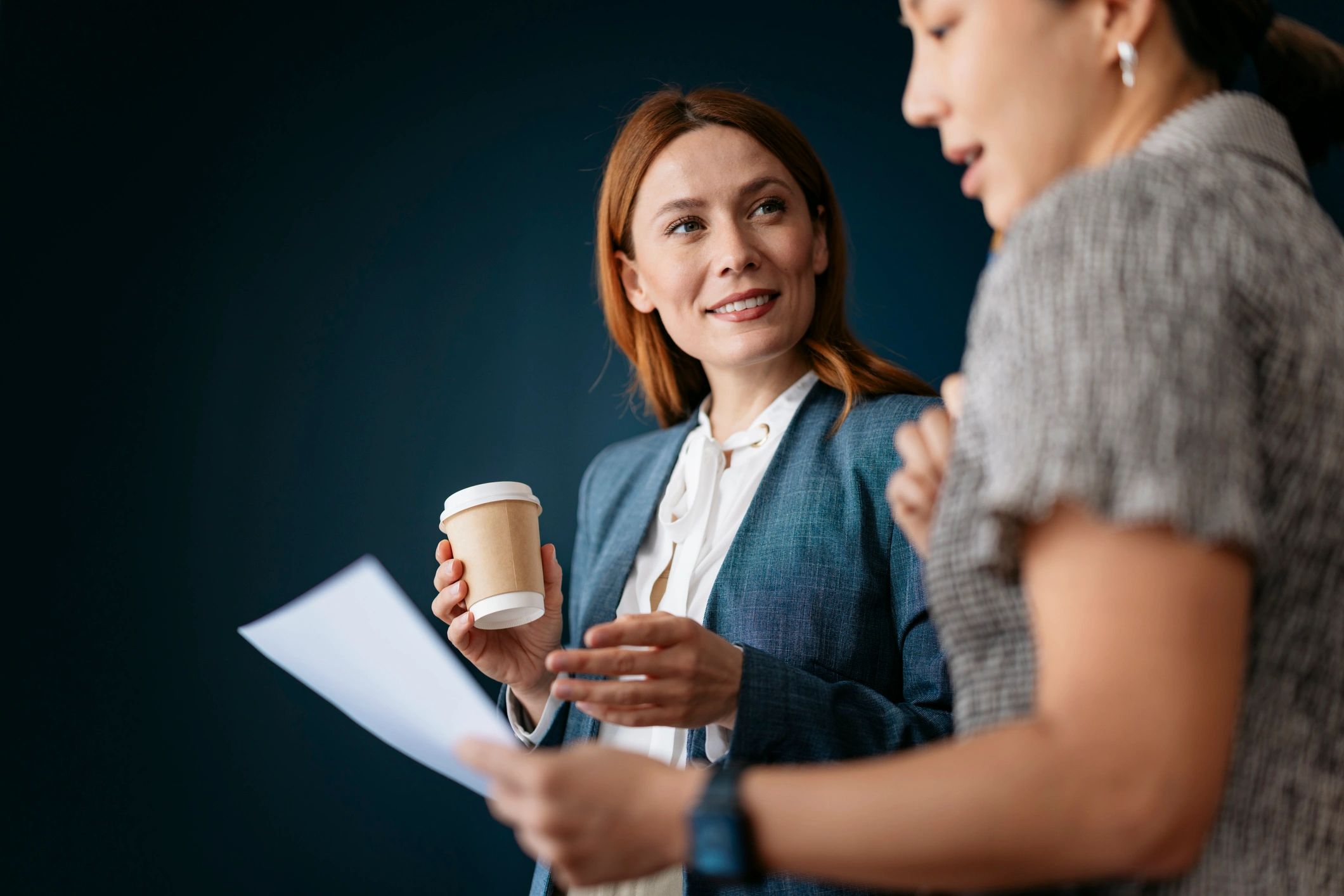 Two professionals collaborating during a business meeting